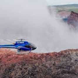 A helicopter lands on a volcano crater in Hawaii